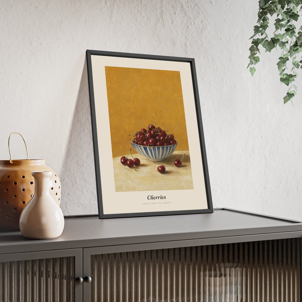 Cherries Print framed and leaning on a sideboard