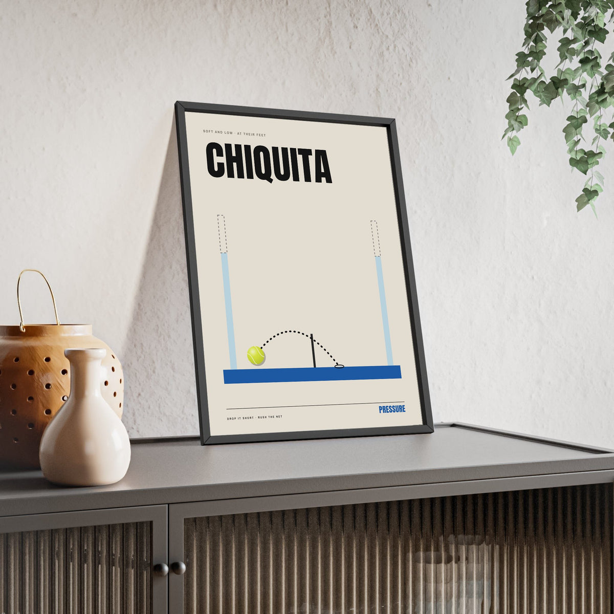 Chiquita Padel print framed and leaning on a sideboard