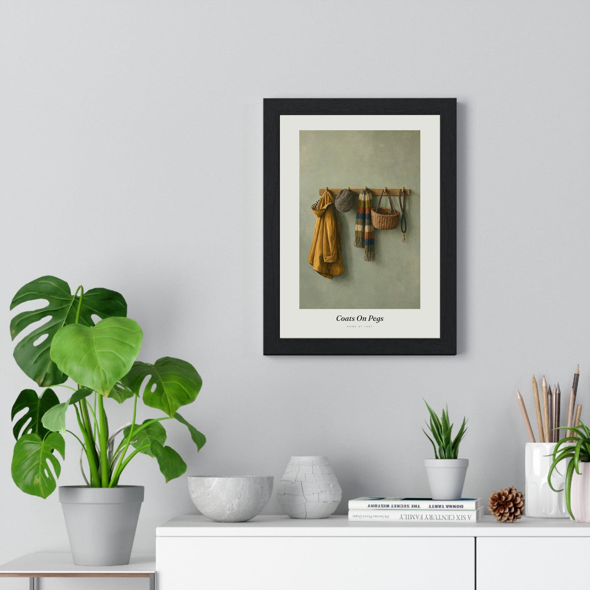 Coats on Pegs Print framed on a living room wall