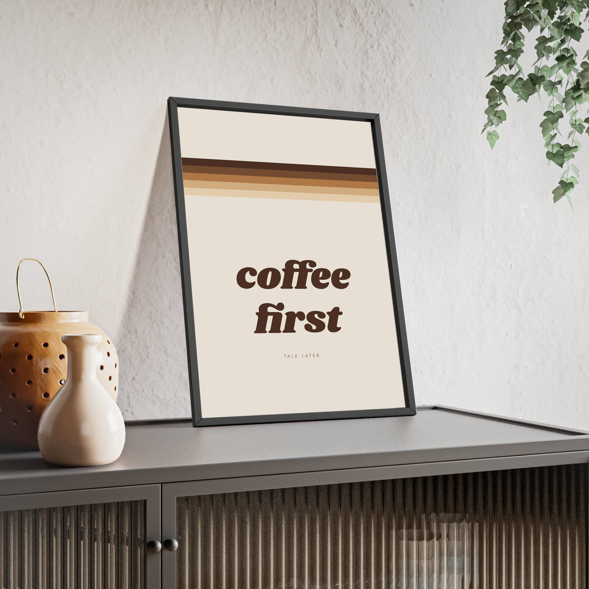 Coffee First Print framed and leaning on a sideboard