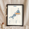 Cornish Sayings Print in a black frame propped up on linen