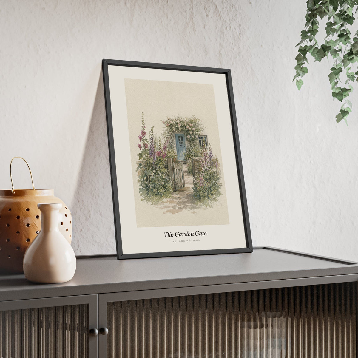 Cottage Garden Gate Print framed and leaning on a sideboard