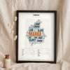Cumbrian Sayings Print in a black frame propped up on linen