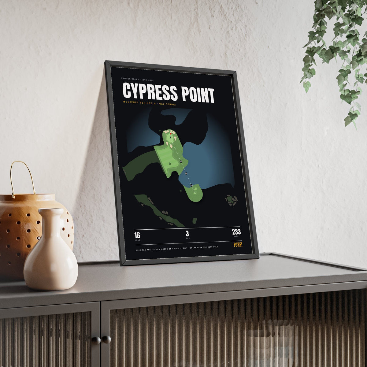 Cypress Point 16th Hole print framed and leaning on a sideboard