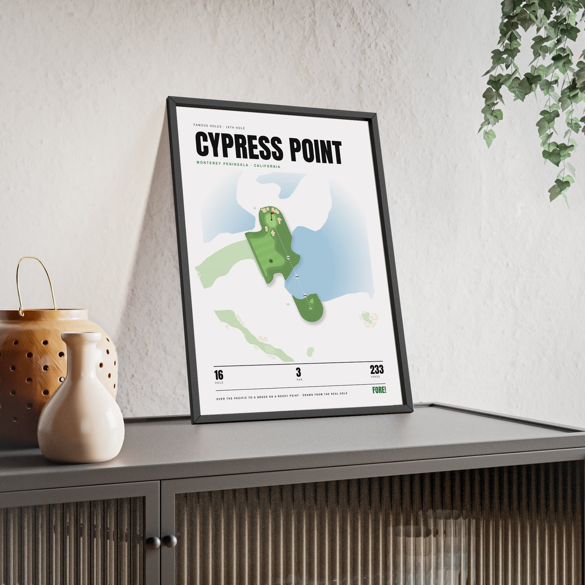 Cypress Point 16th Hole White print framed and leaning on a sideboard