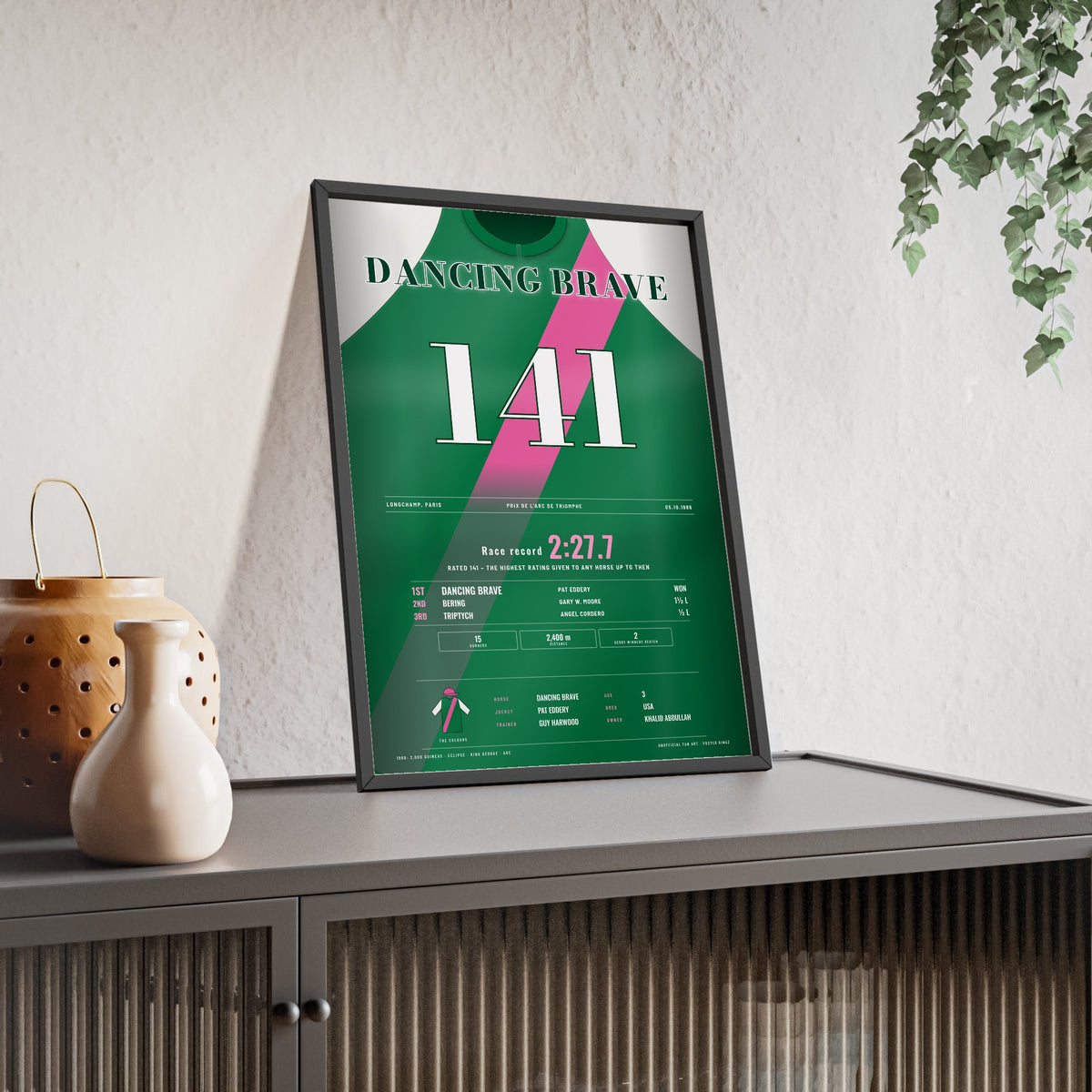 Dancing Brave Prix de l'Arc de Triomphe 1986 Horse Racing Poster - Rated 141 Silks Print framed and leaning on a sideboard