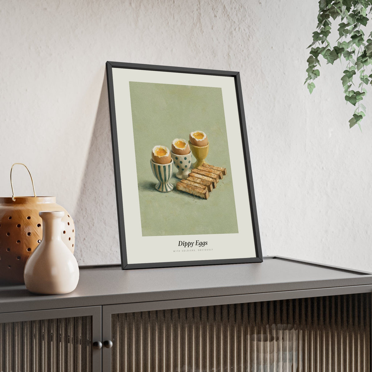 Dippy Eggs and Soldiers Print framed and leaning on a sideboard