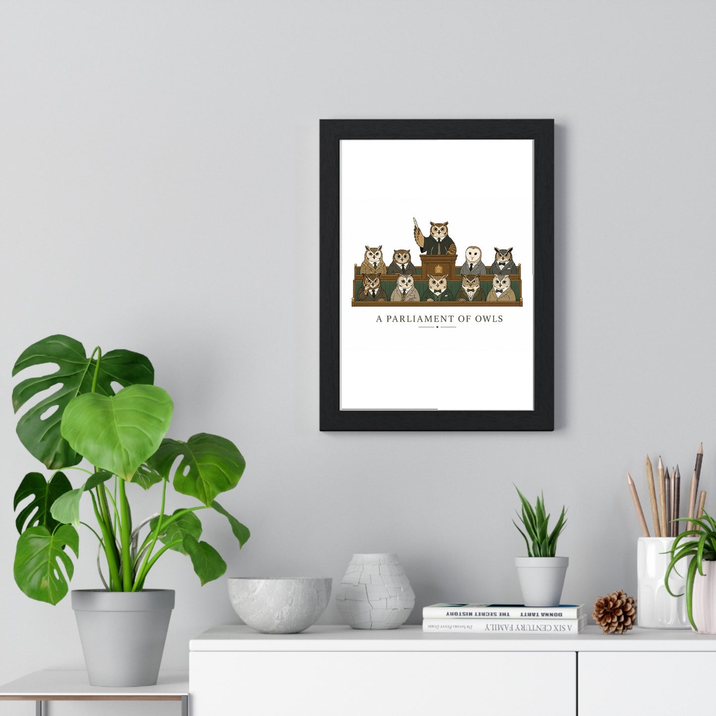 A Parliament of Owls framed poster displayed on living room wall