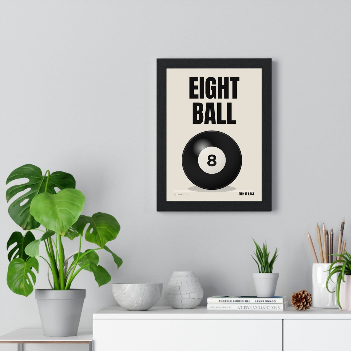 Eight Ball print framed on a living room wall