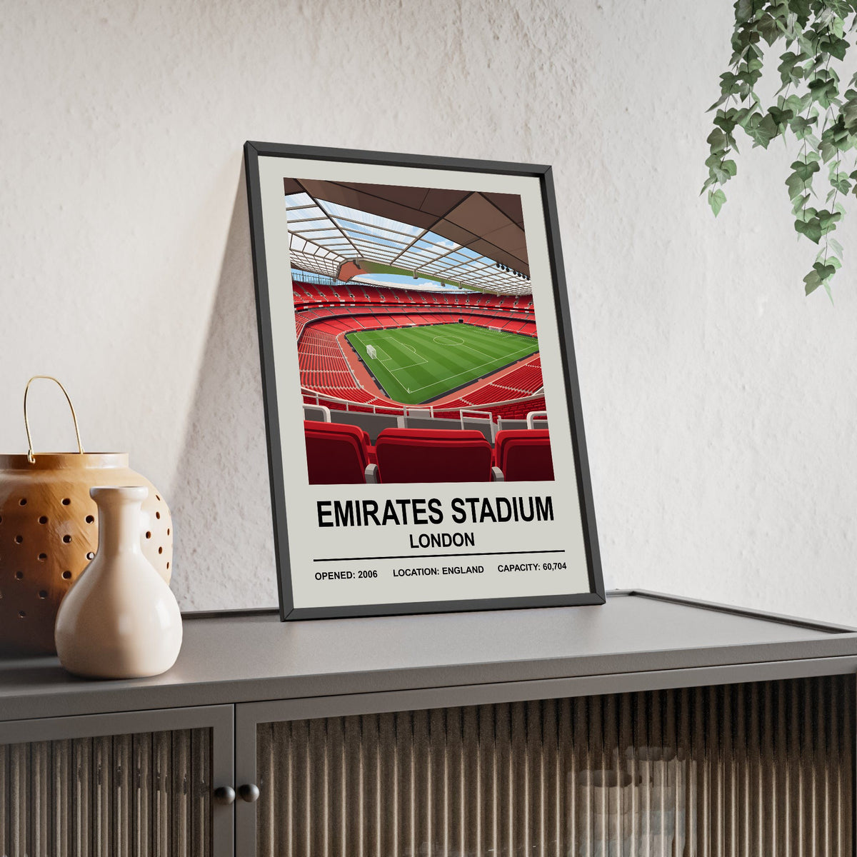 Arsenal Emirates Stadium print framed and leaning on a sideboard