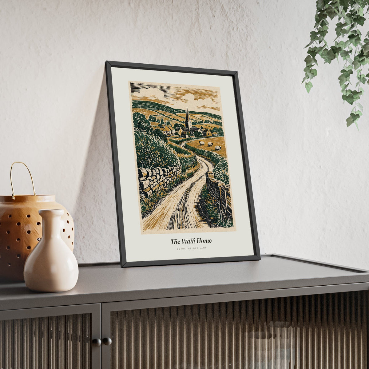 English Country Lane Print framed and leaning on a sideboard