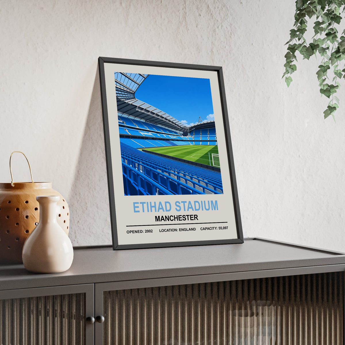Manchester City Etihad Stadium print framed and leaning on a sideboard