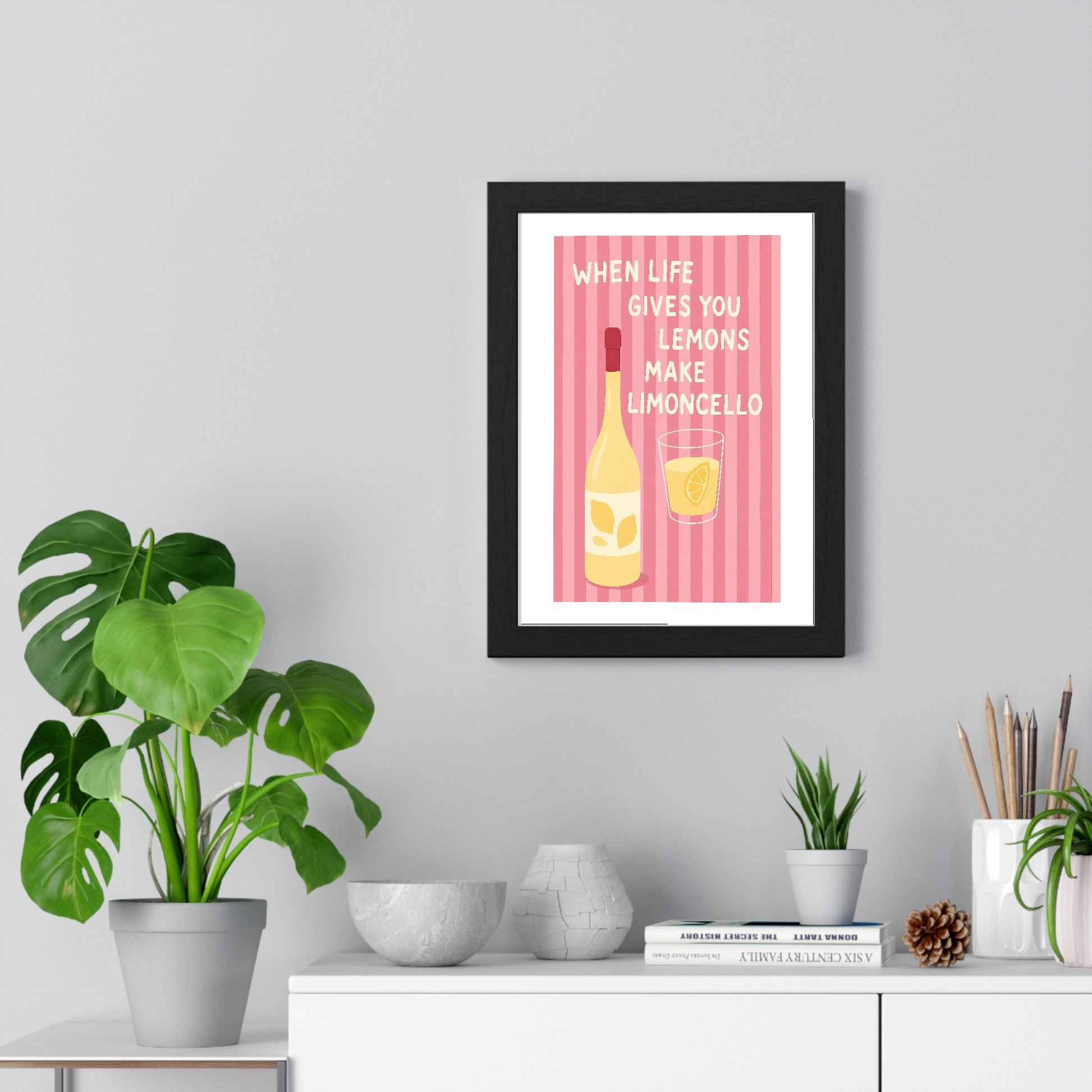 Limoncello poster framed on living room wall showing pink striped motivational design