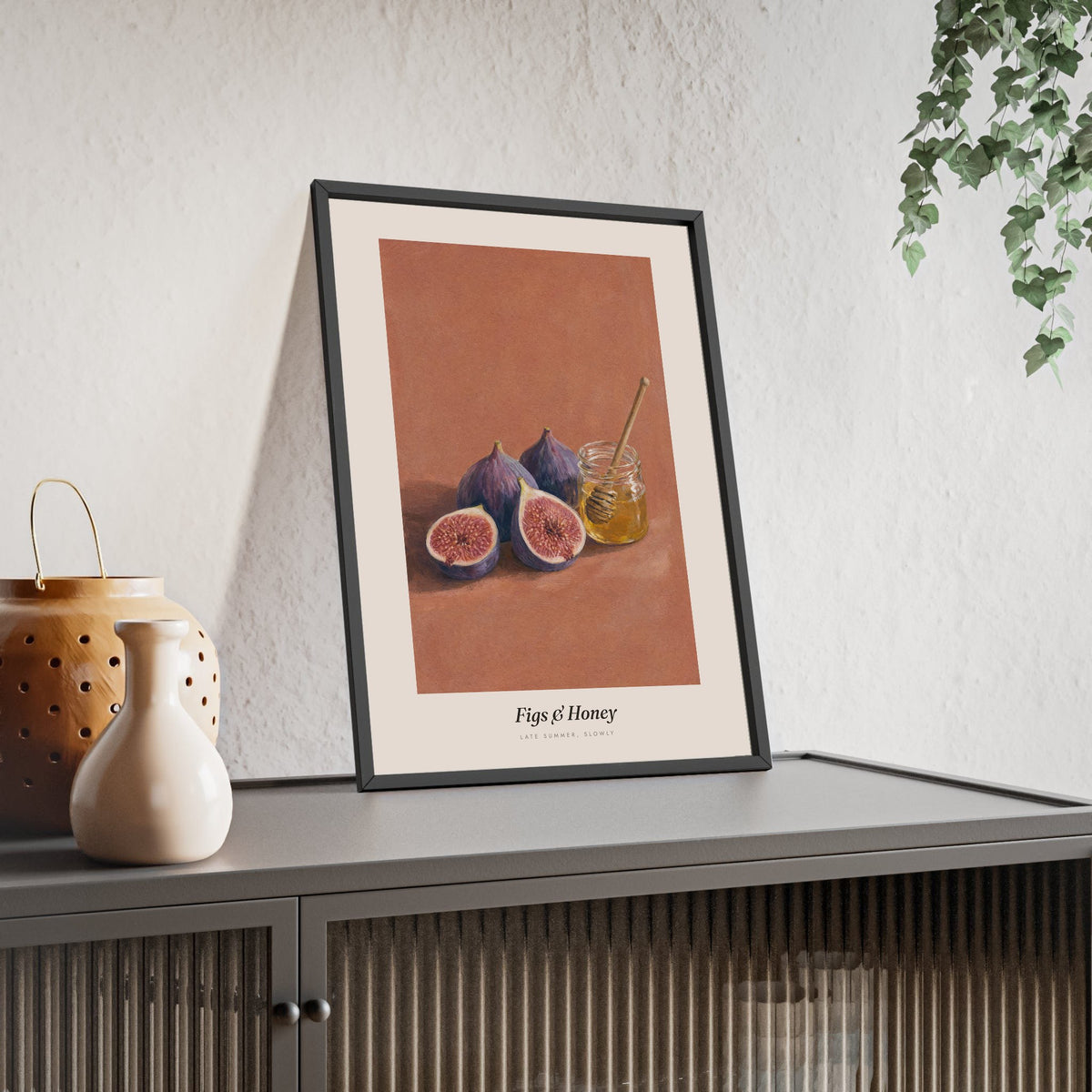 Figs and Honey Print framed and leaning on a sideboard