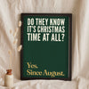 Funny Do They Know It's Christmas? lyric print in a black frame propped up on linen