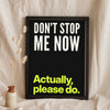 Funny Don't Stop Me Now lyric print in a black frame propped up on linen