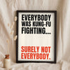 Funny Kung Fu Fighting lyric print in a black frame propped up on linen