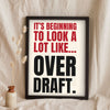 Funny It's Beginning to Look a Lot Like Christmas lyric print in a black frame propped up on linen