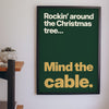 Funny Rockin' Around the Christmas Tree lyric print framed on a wall