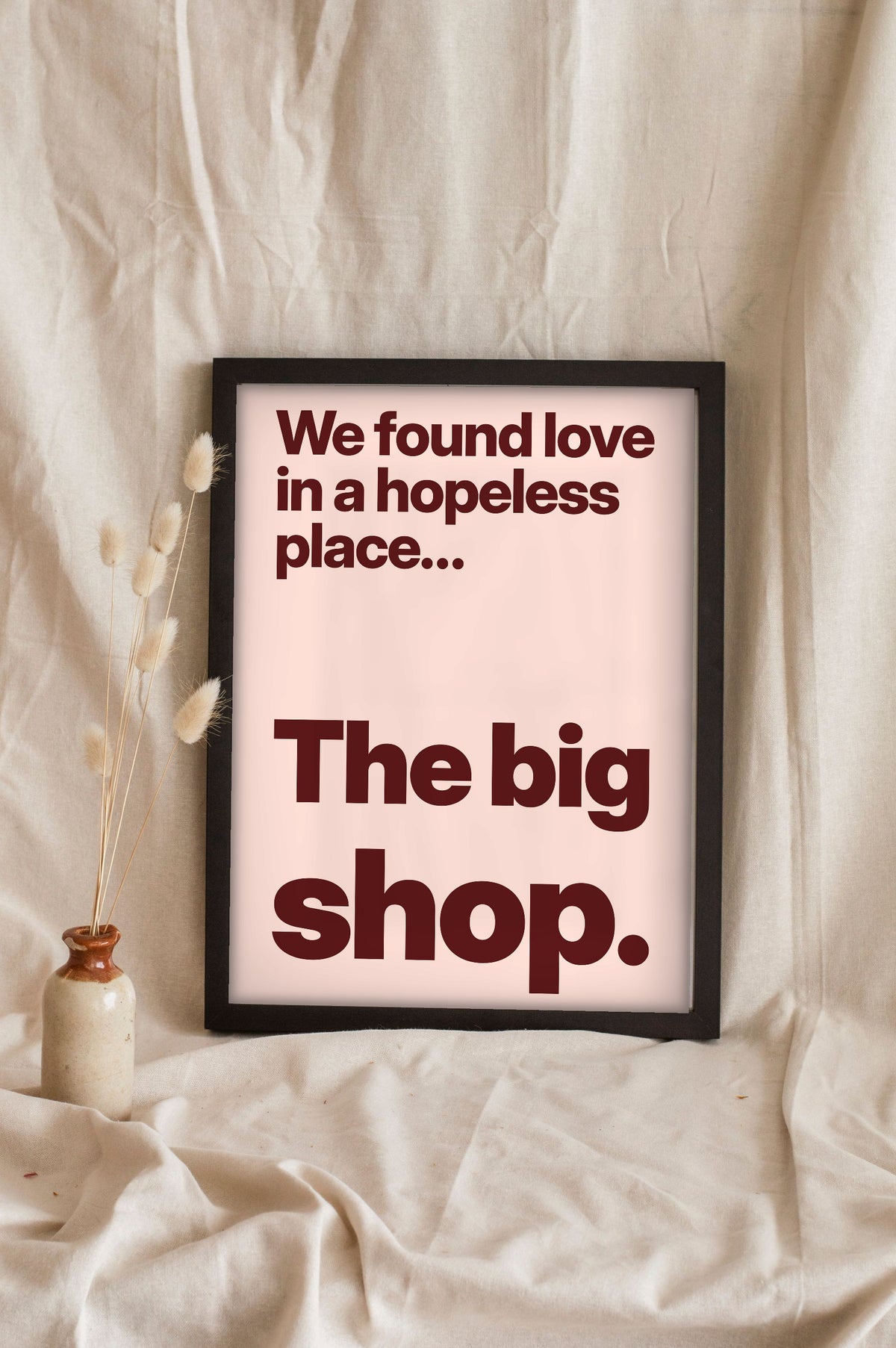 Funny We Found Love lyric print in a black frame propped up on linen