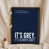Funny White Christmas lyric print in a black frame propped up on linen
