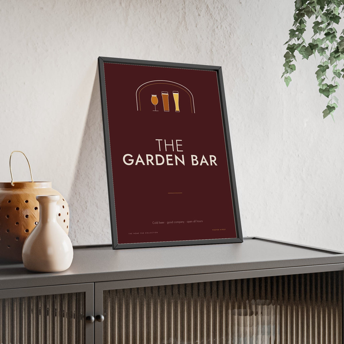 The Garden Bar Sign Print framed and leaning on a sideboard