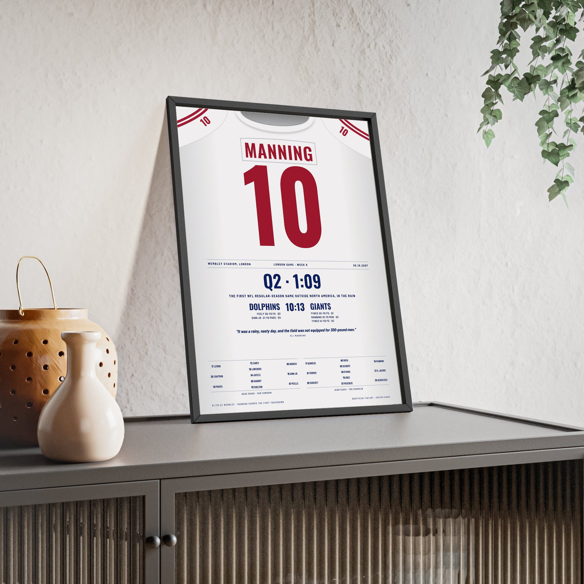 New York Giants London 2007 Poster - Eli Manning 10 First NFL Game at Wembley Jersey Print framed and leaning on a sideboard