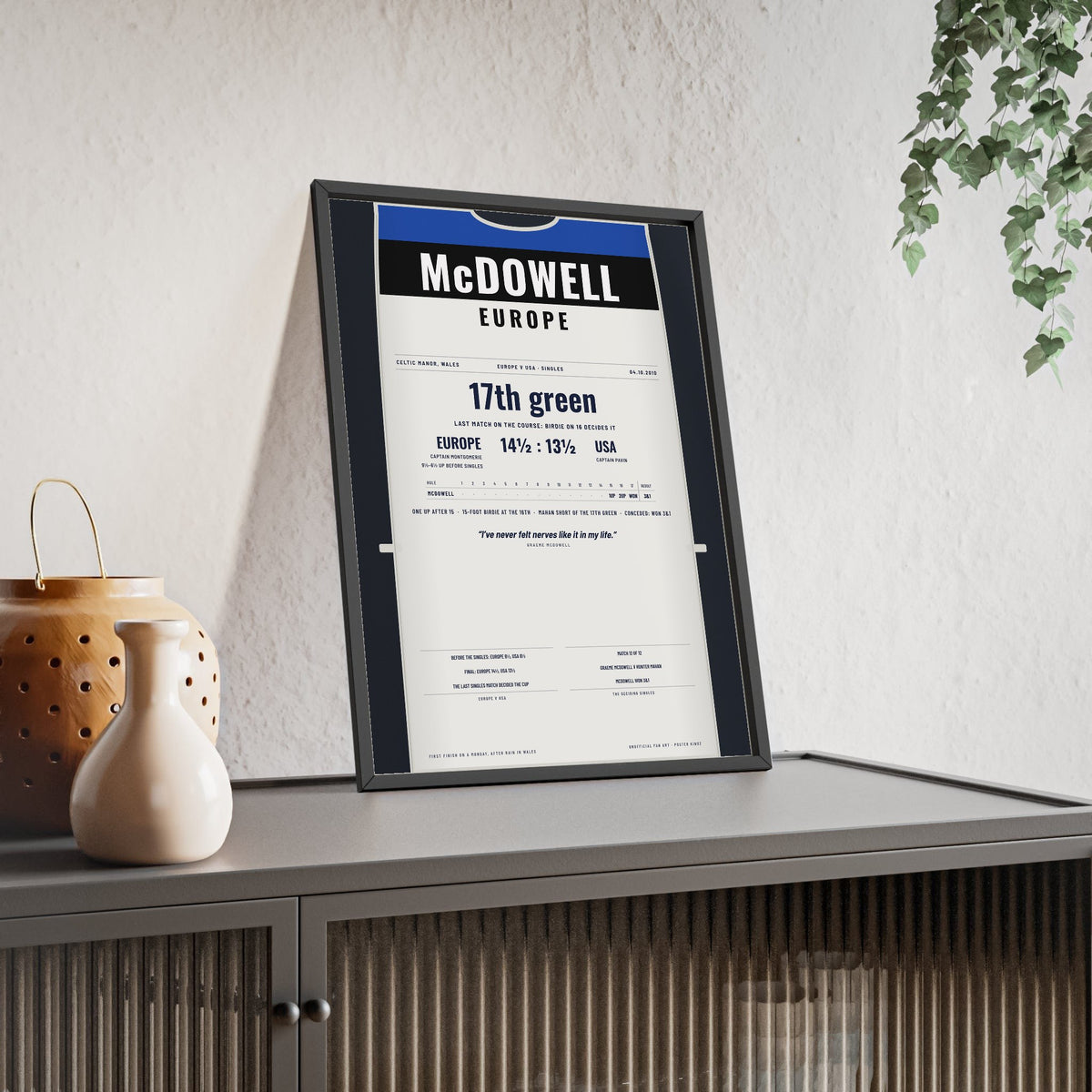 Graeme McDowell Celtic Manor 2010 Golf Poster - Caddie Bib Europe v USA Winning Point Print framed and leaning on a sideboard