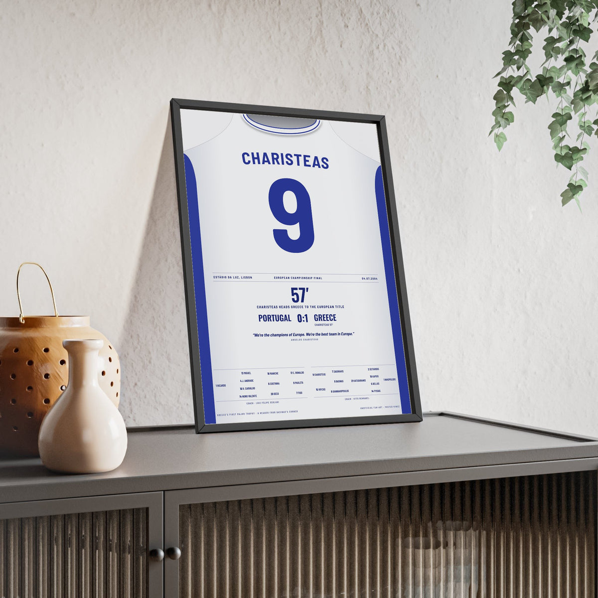 Greece Euro 2004 Final Poster - Angelos Charisteas 9 Header v Portugal Shirt Print framed and leaning on a sideboard