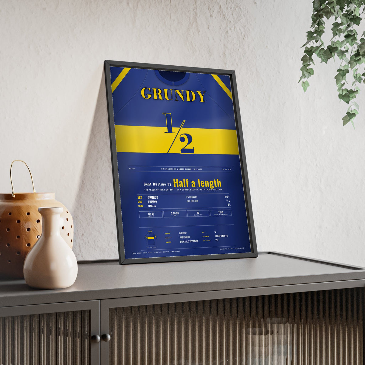 Grundy King George 1975 Horse Racing Poster - Race of the Century Silks Print framed and leaning on a sideboard
