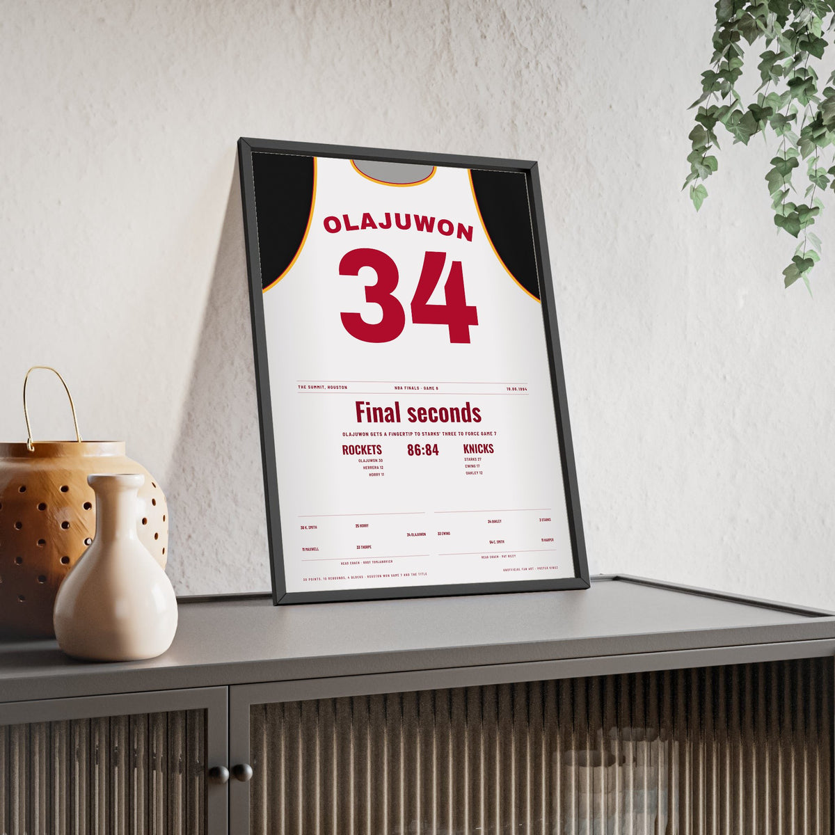 Hakeem Olajuwon 1994 NBA Finals Game 6 Block Poster - Houston Rockets 34 Jersey Print framed and leaning on a sideboard
