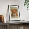 Highland Cow Tea Print framed and leaning on a sideboard