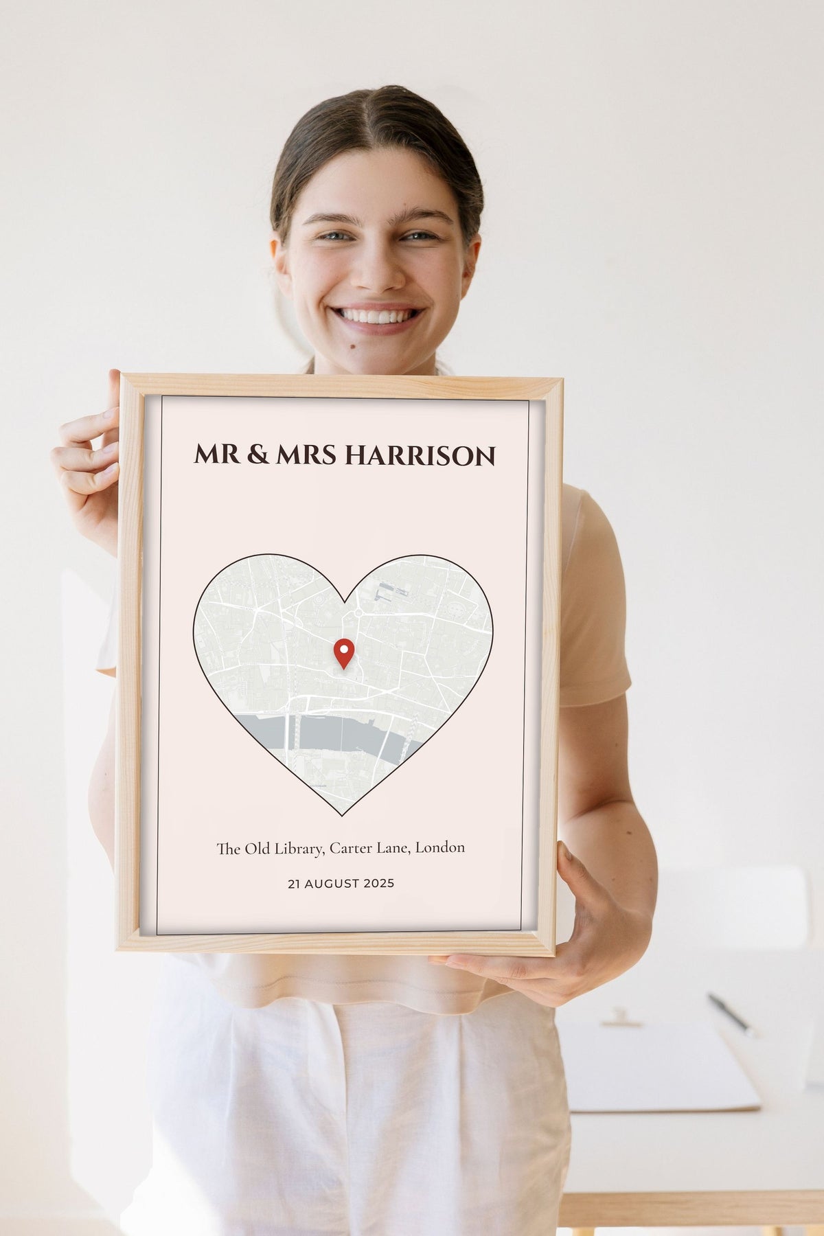 Personalised Wedding Venue Heart Map Print - Lifestyle - held by a smiling woman