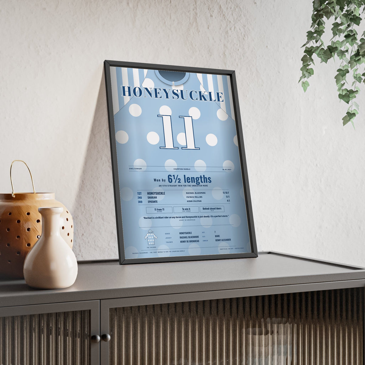 Honeysuckle Champion Hurdle 2021 Horse Racing Poster - Unbeaten Mare Silks Print framed and leaning on a sideboard