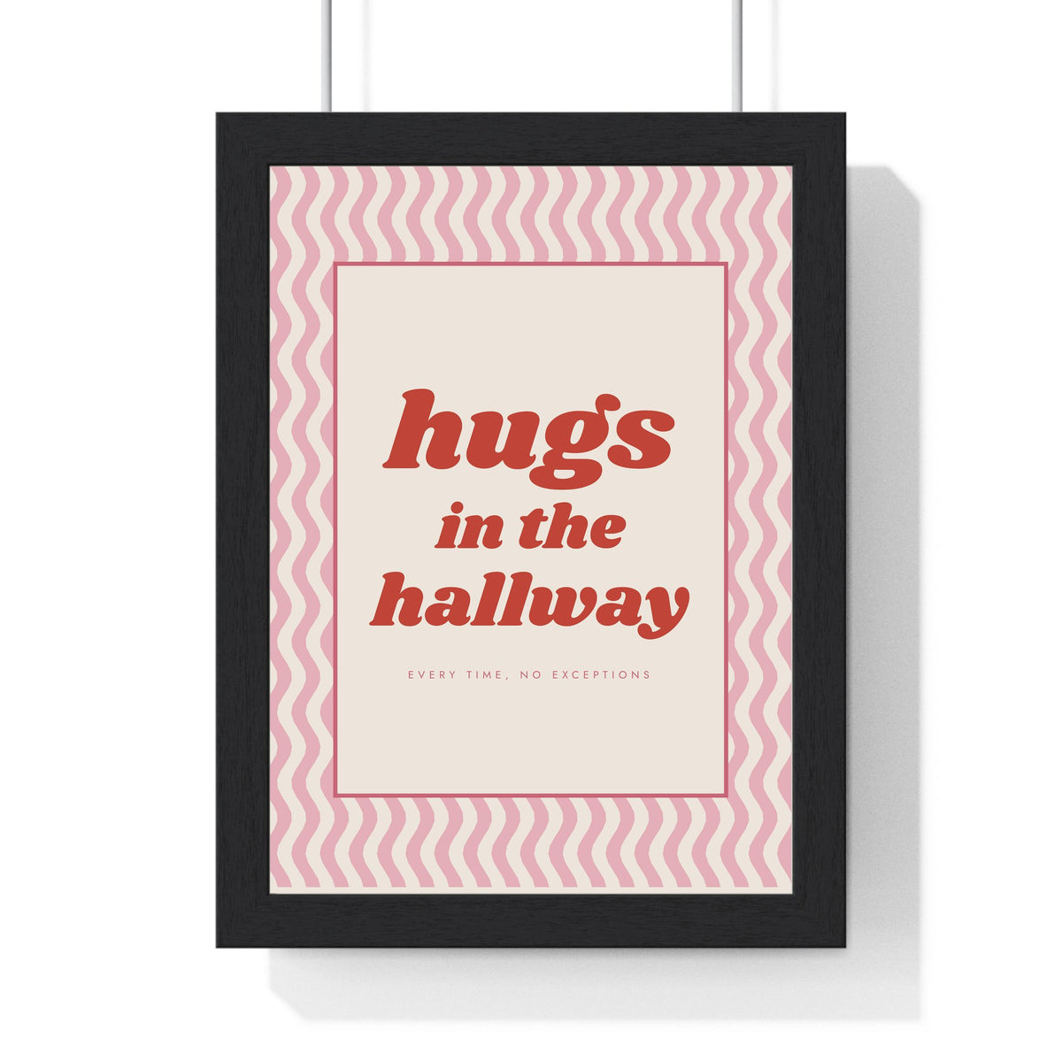 Hugs in the Hallway Print framed in a black frame, ready to hang