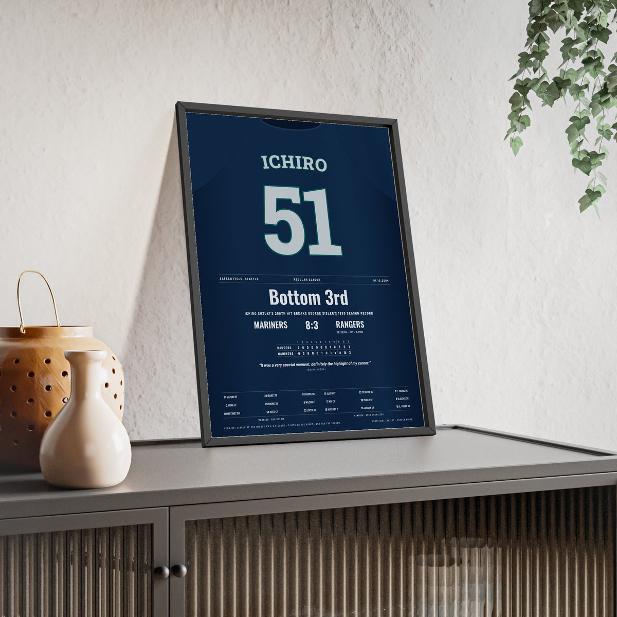 Ichiro Suzuki 2004 Record 258th Hit Poster - Seattle Mariners 51 Jersey Print framed and leaning on a sideboard