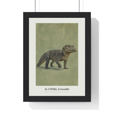 In a While Crocodile Print framed in a black frame, ready to hang