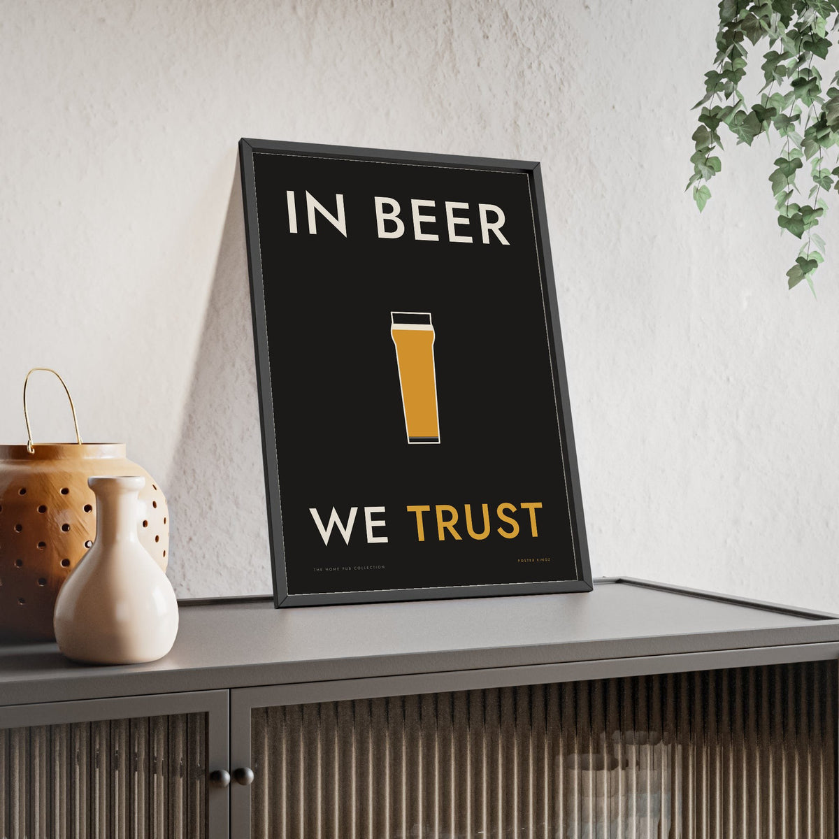 In Beer We Trust Print framed and leaning on a sideboard