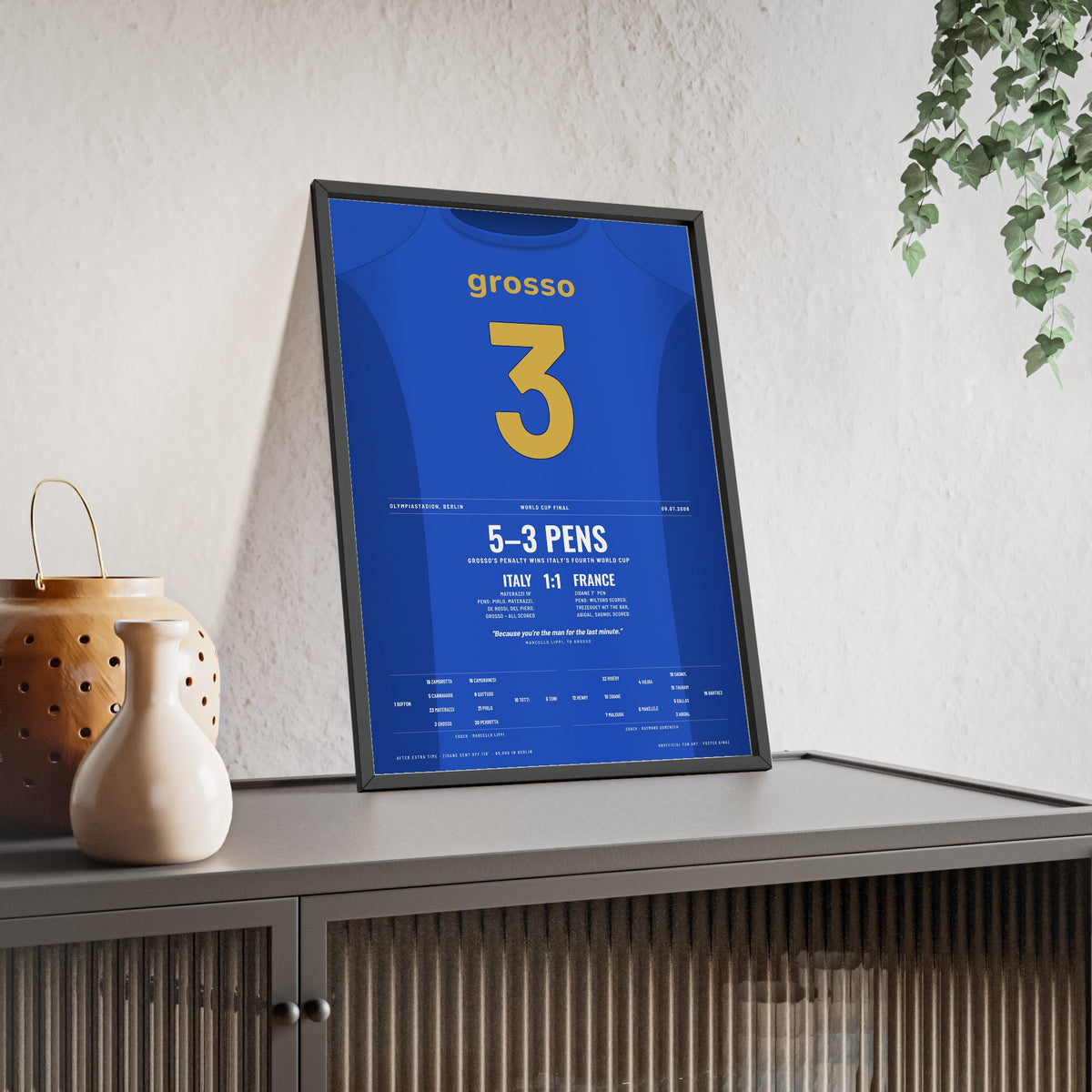 Italy World Cup Final 2006 Poster - Fabio Grosso 3 Winning Penalty v France Shirt Print framed and leaning on a sideboard