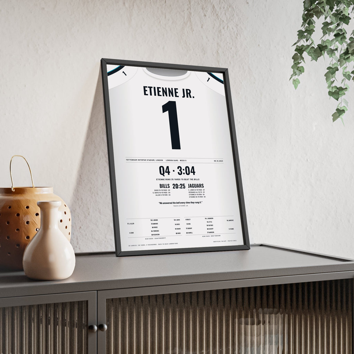 Jacksonville Jaguars London 2023 Poster - Travis Etienne Jr 1 Tottenham v Bills Jersey Print framed and leaning on a sideboard