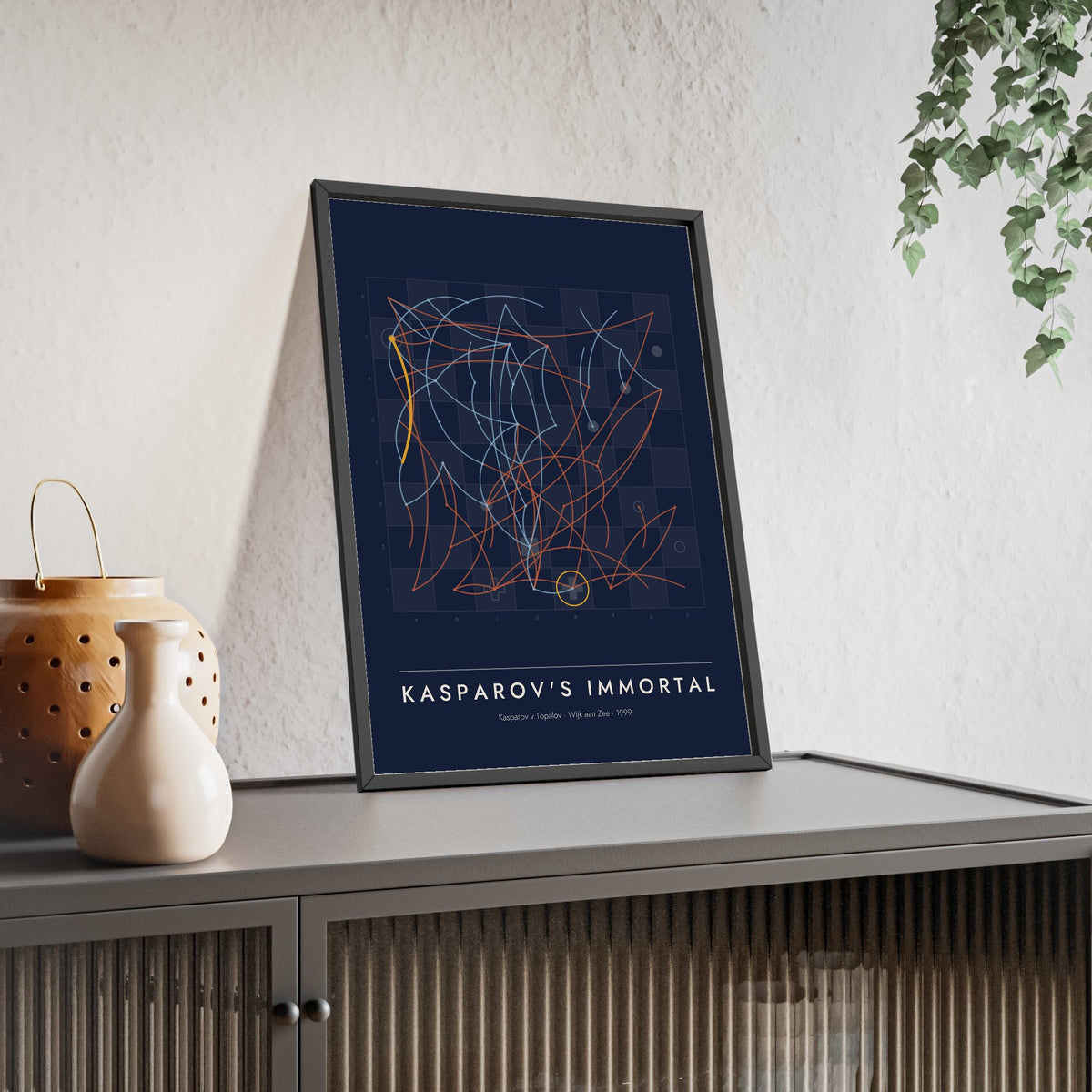 Kasparov's Immortal Chess print framed and leaning on a sideboard