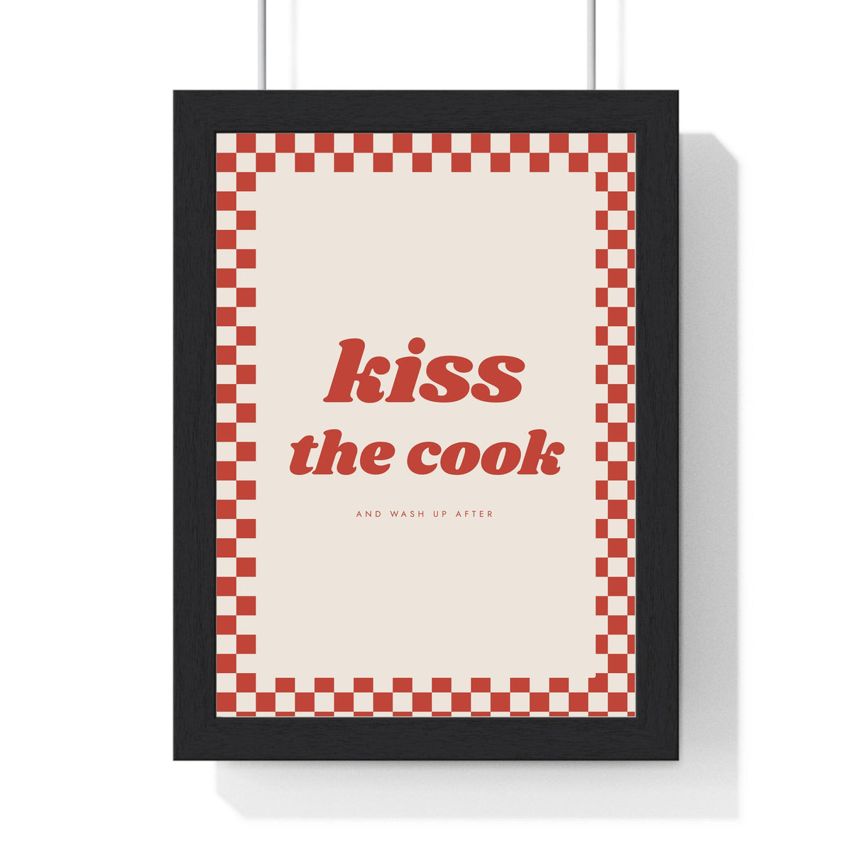 Kiss the Cook Print framed in a black frame, ready to hang