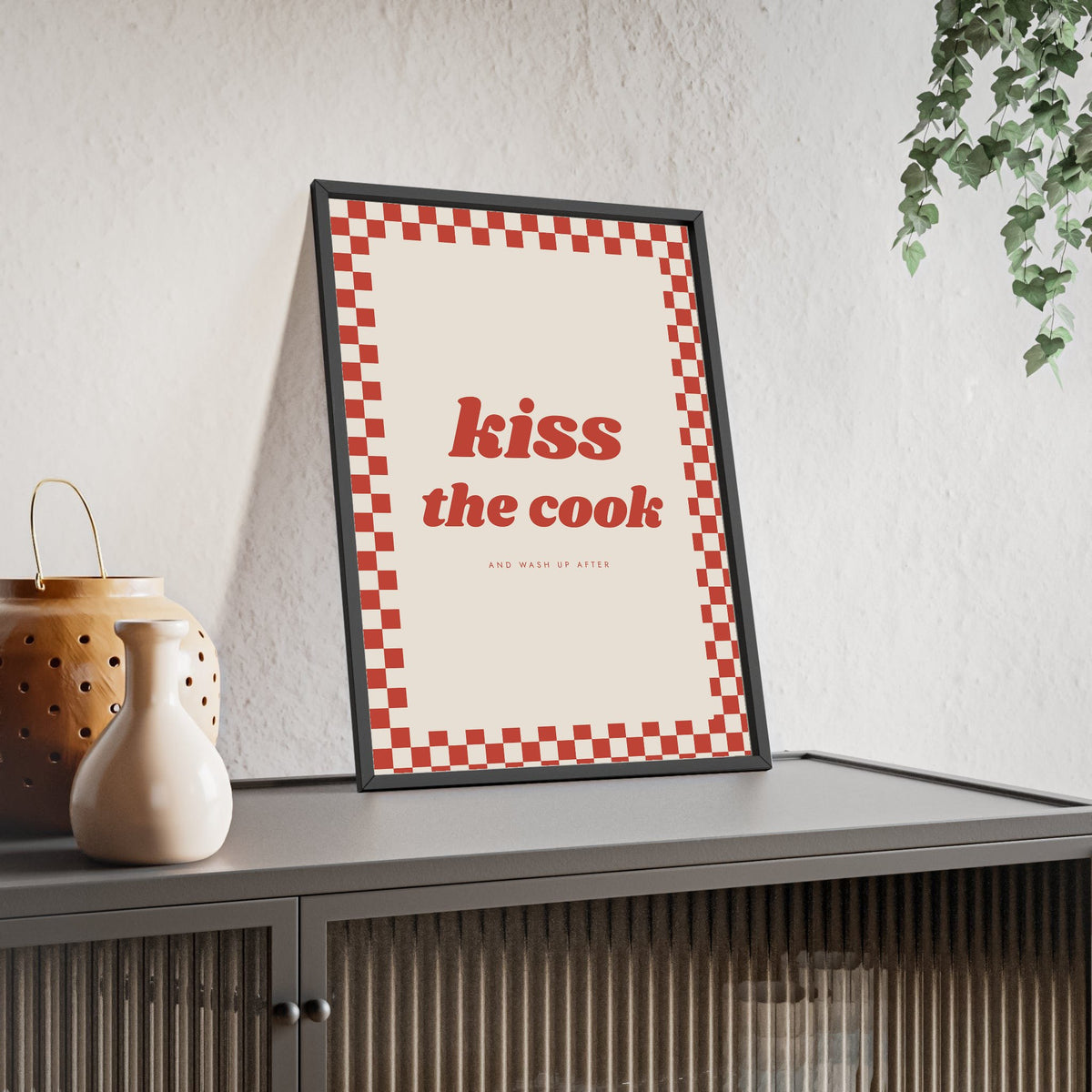 Kiss the Cook Print framed and leaning on a sideboard