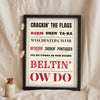 Lancashire Slang Print in a black frame propped up on linen