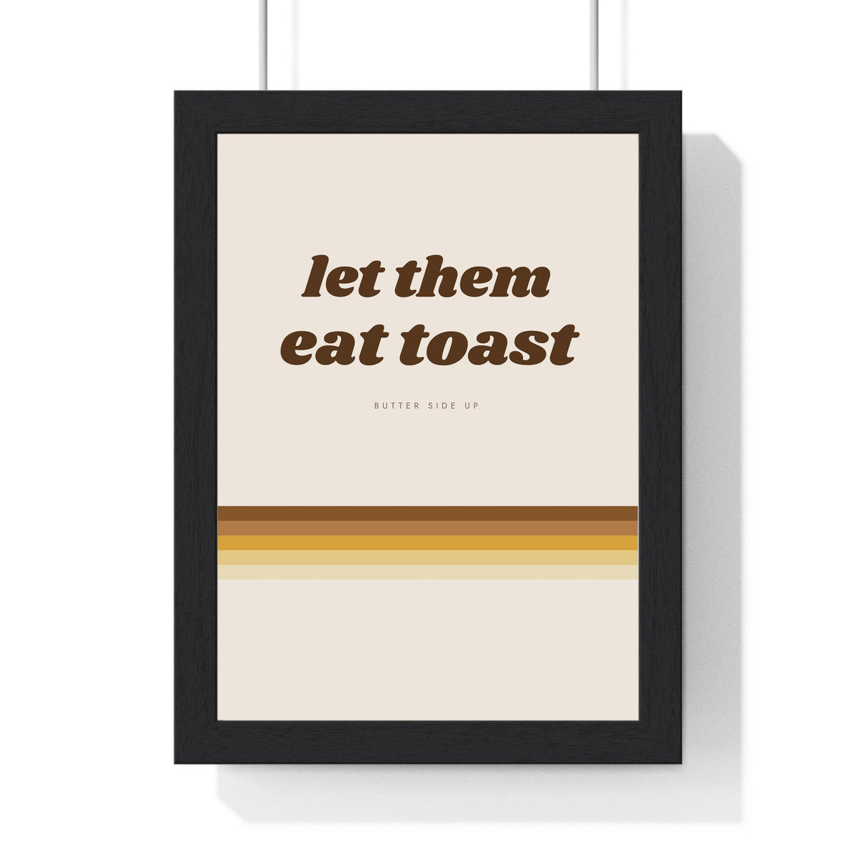 Let Them Eat Toast Print framed in a black frame, ready to hang