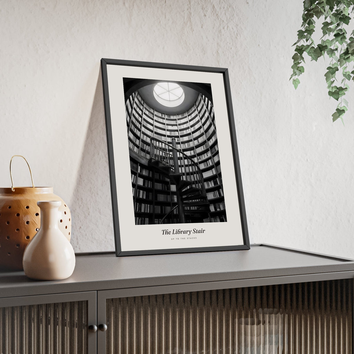 Library Spiral Staircase Print - Home Office Wall Art framed and leaning on a sideboard