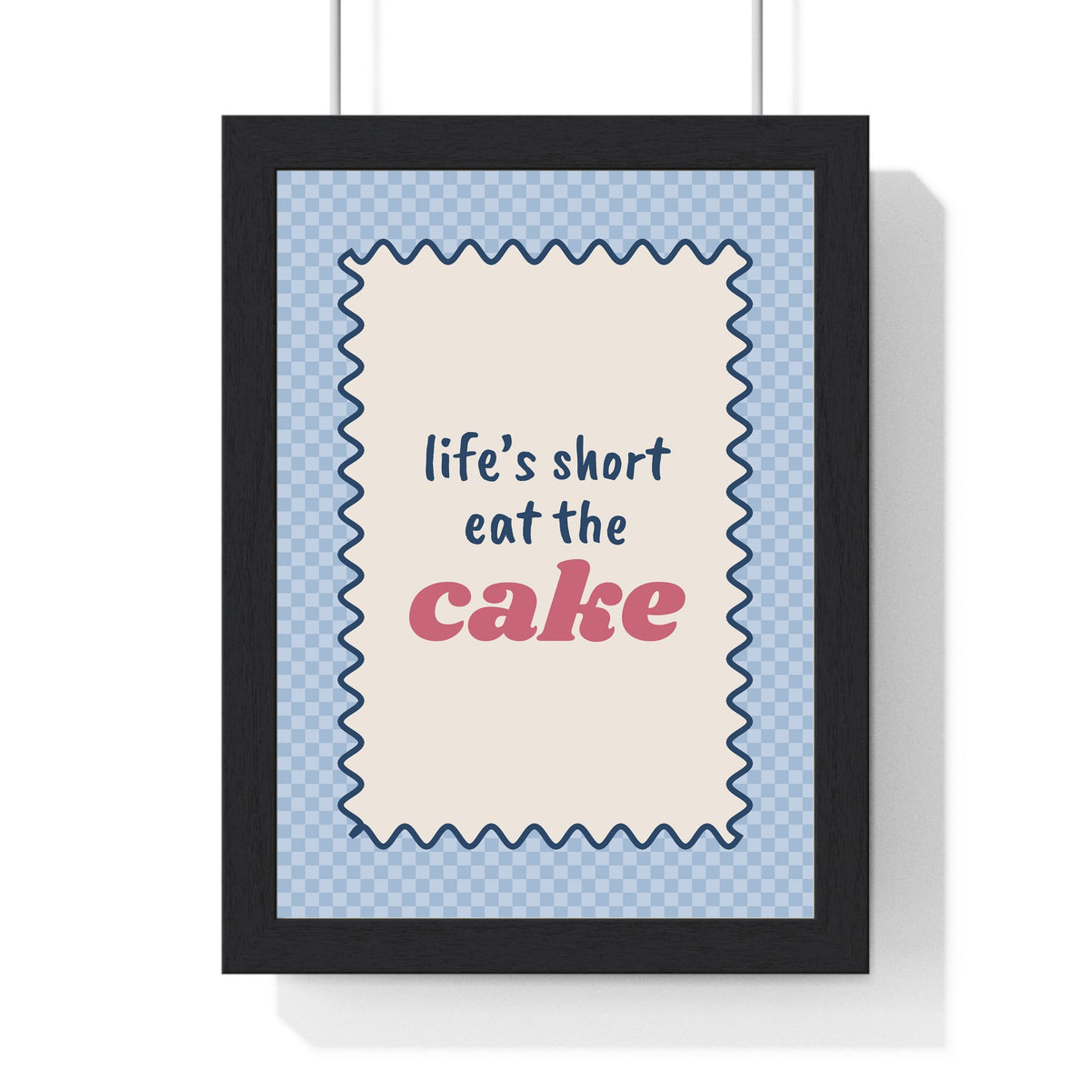 Life's Short Eat the Cake Print framed in a black frame, ready to hang