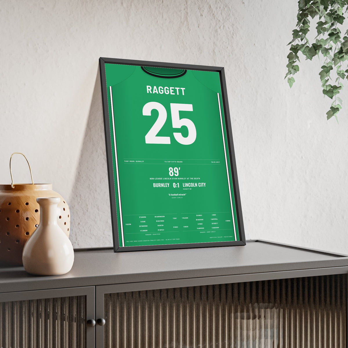 Lincoln City FA Cup 2017 Poster - Sean Raggett 25 Turf Moor Winner Shirt Print framed and leaning on a sideboard