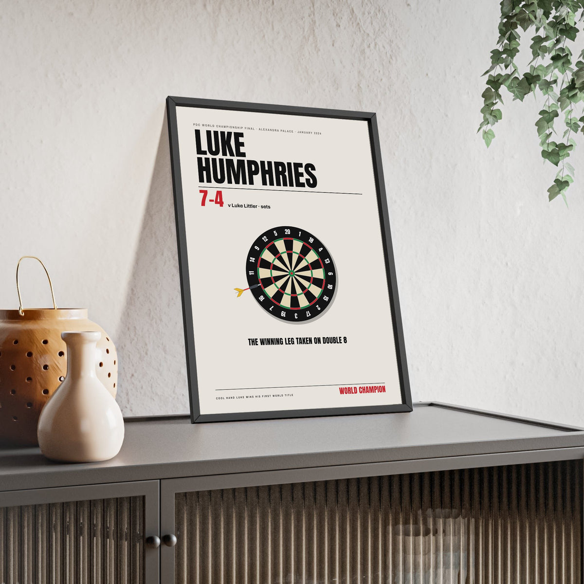 Luke Humphries World Darts Champion 2024 print framed and leaning on a sideboard