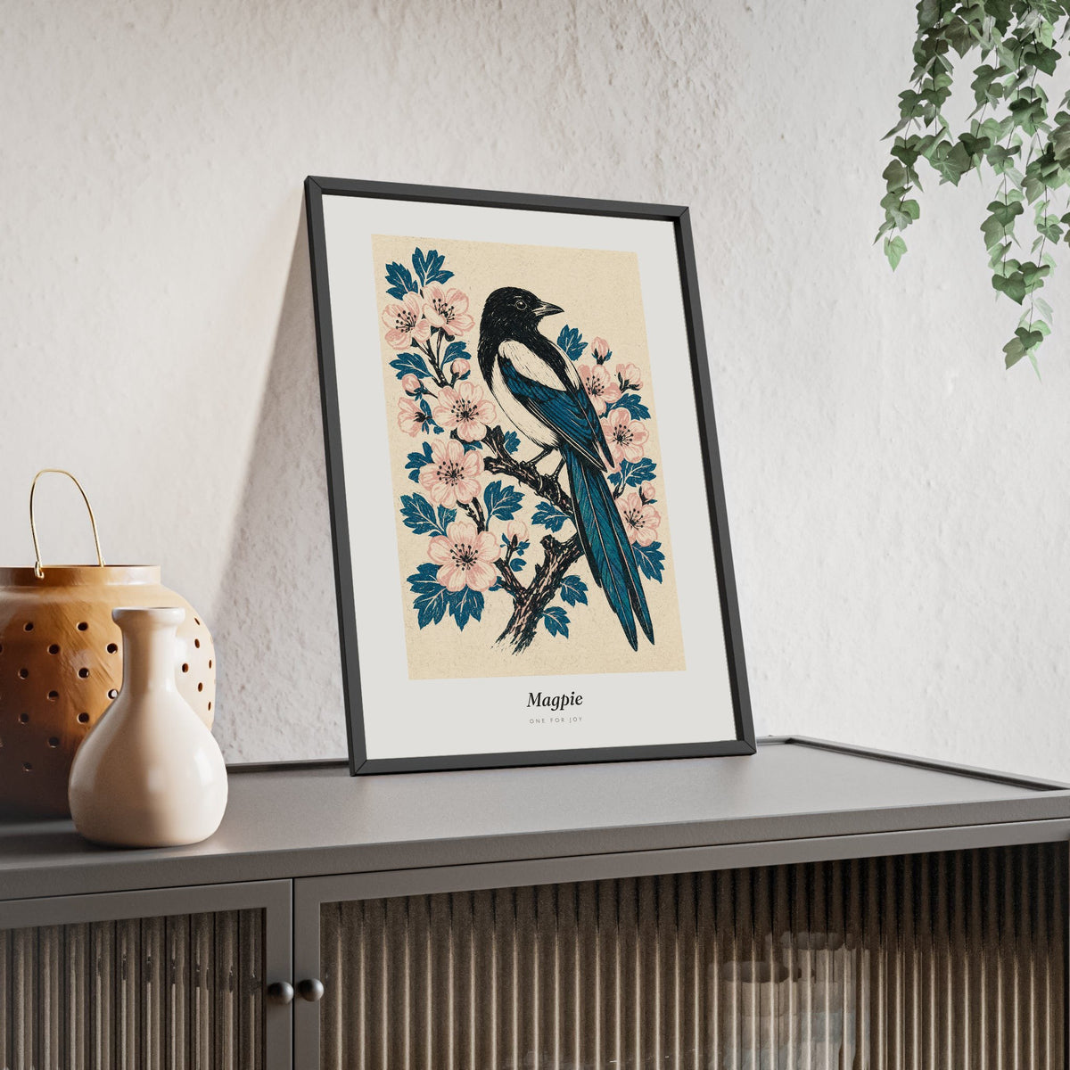 Magpie Print framed and leaning on a sideboard